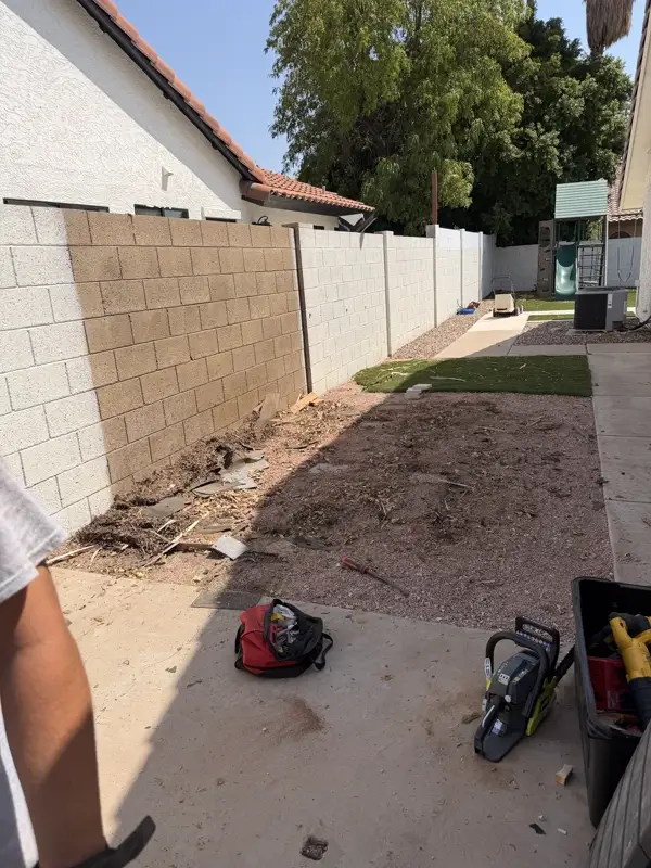 Shed removed, leaving a clean outline on the block wall where it stood