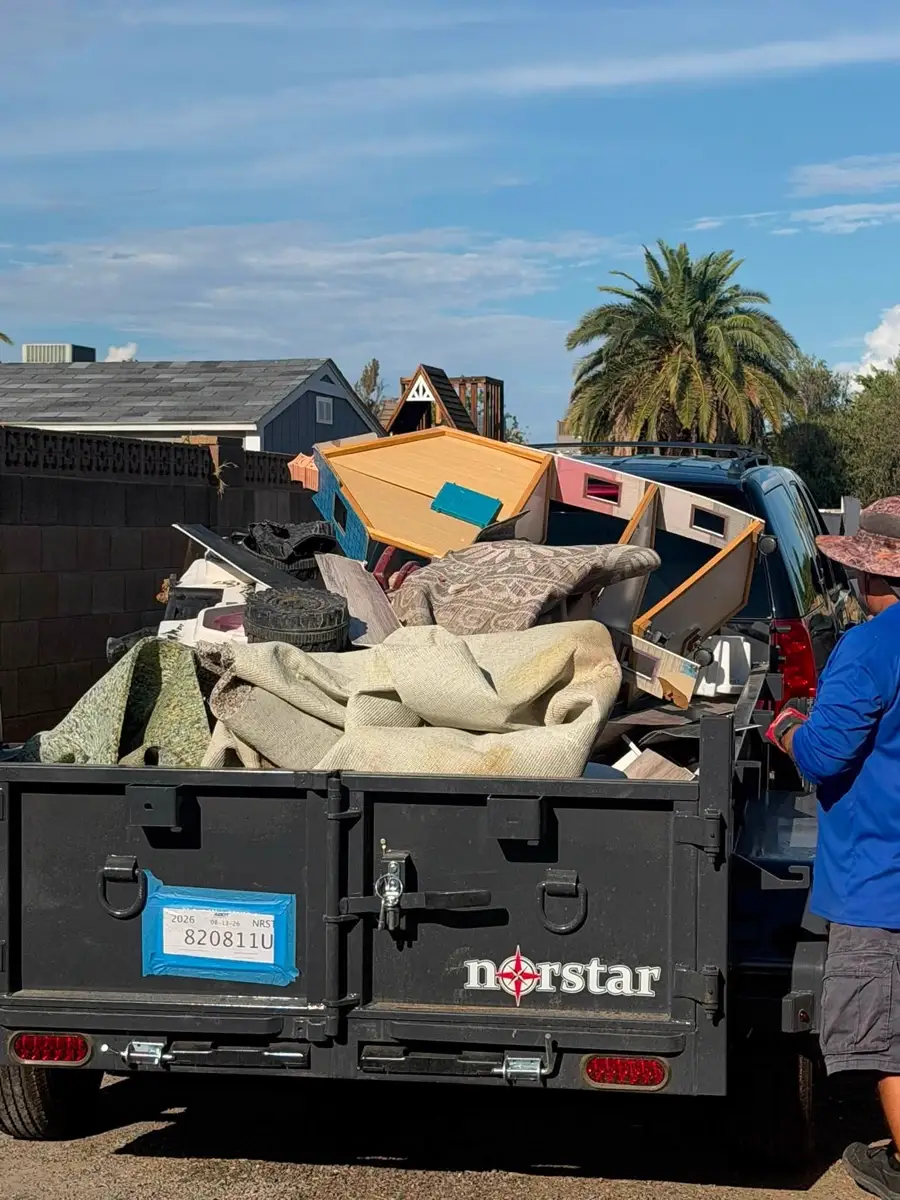 The Roadrunner trailer loaded with old carpet, furniture and household debris on a Phoenix-area job